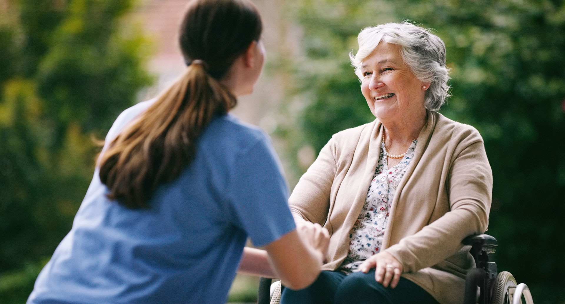 residential-care Lady smiling and talking to nurse